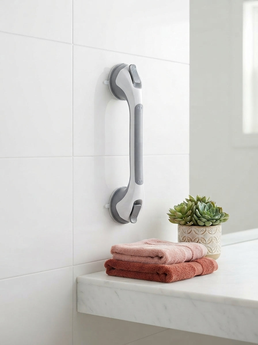 A modern, industrial-strength metallic shower grab bar mounted on a clean white tile wall in a stylish, well-lit bathroom.